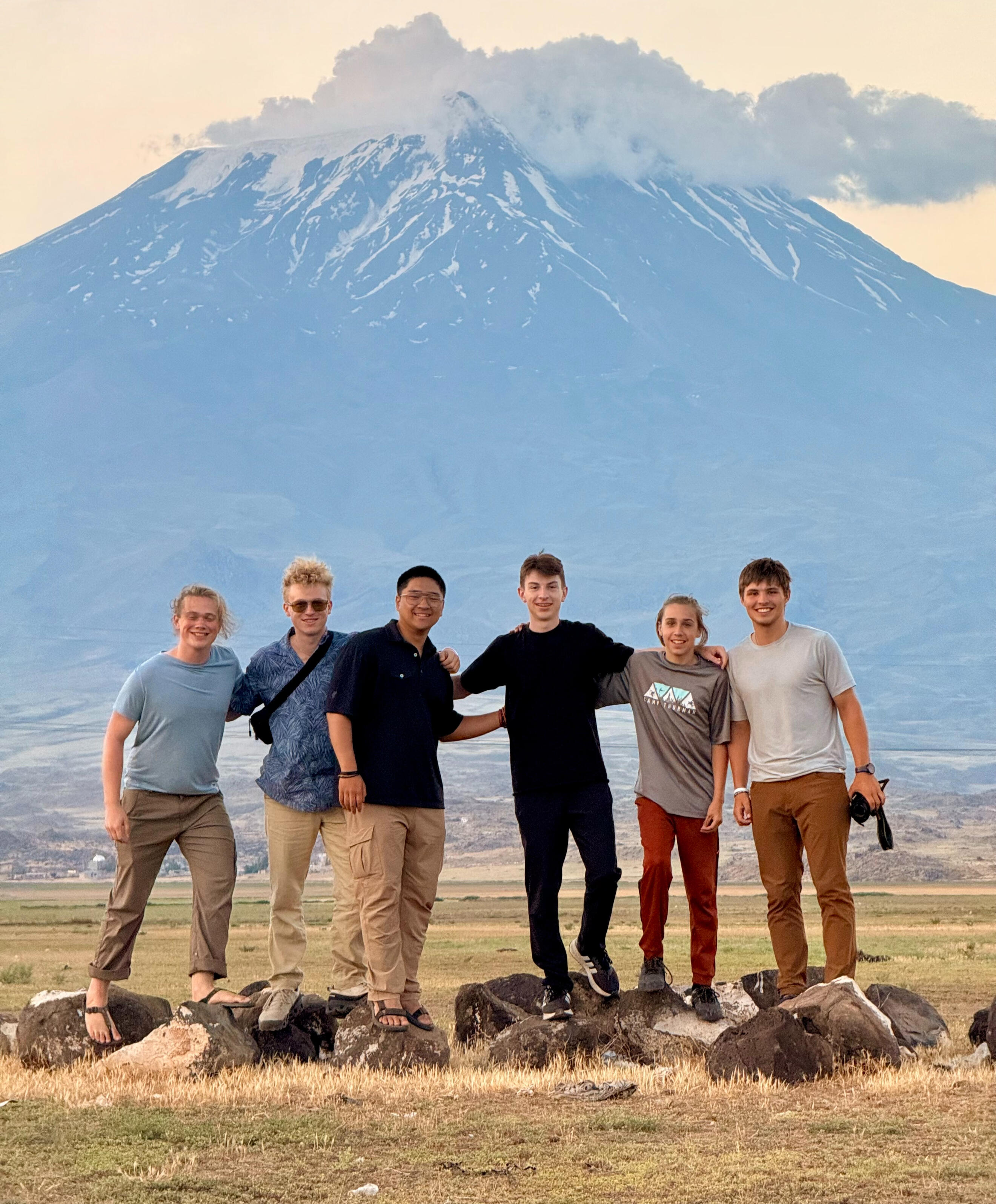 frontier-discovery-project-young-team.jpg Young team stands together in front of mountain