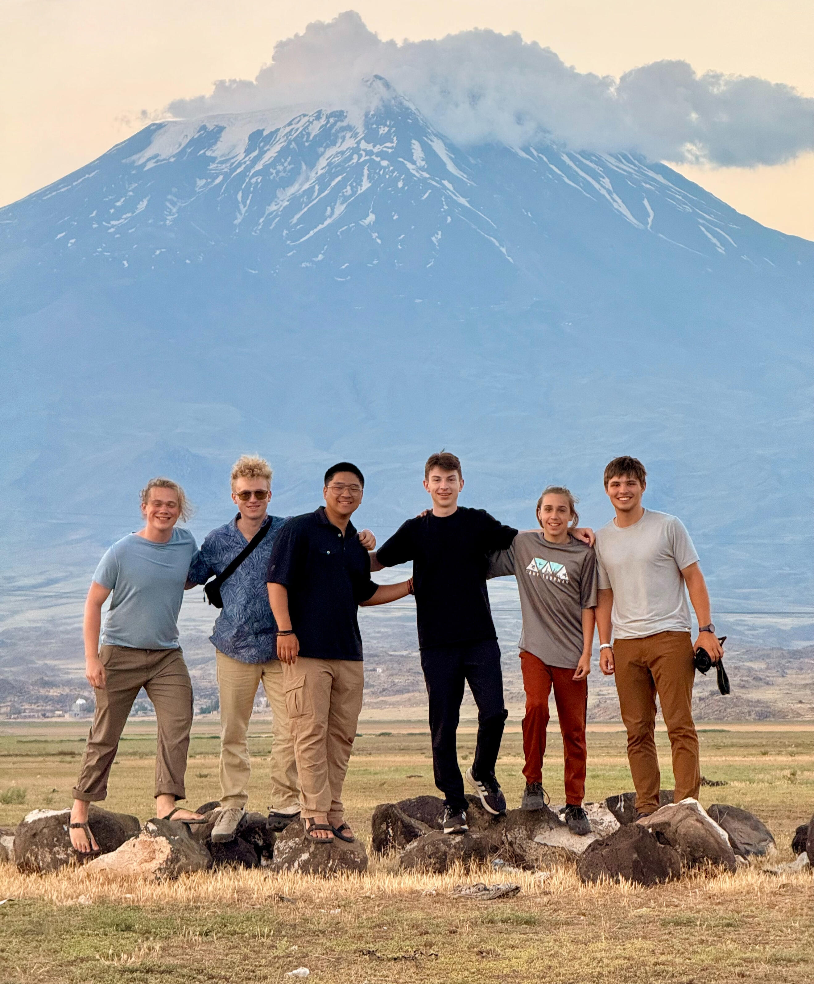frontier-discovery-project-young-team.jpg Young team stands together in front of mountain